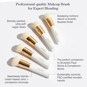Ogee brush being rinsed under water showing easy cleaning and hygiene