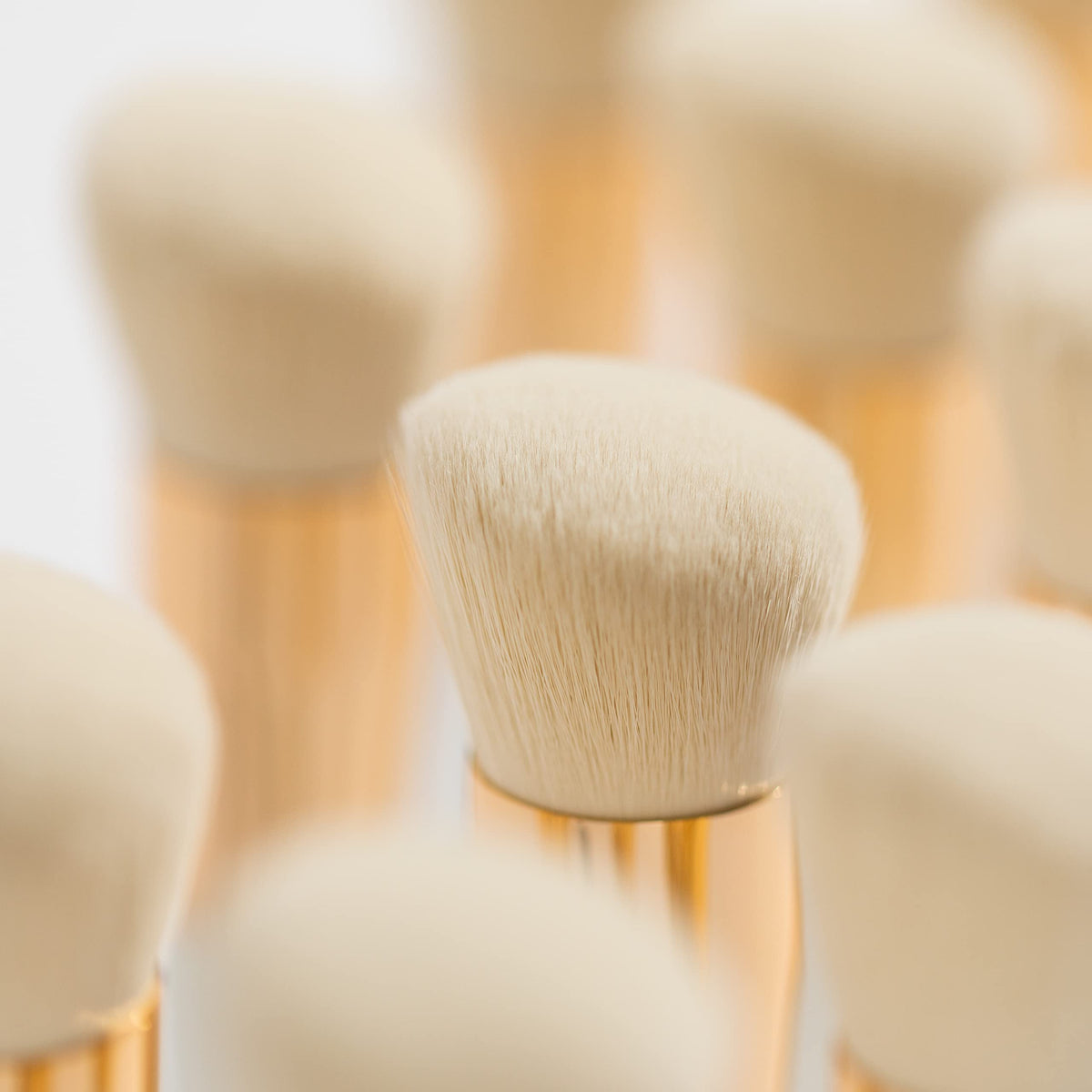 Ogee brush next to hand for size comparison and travel-friendly portability