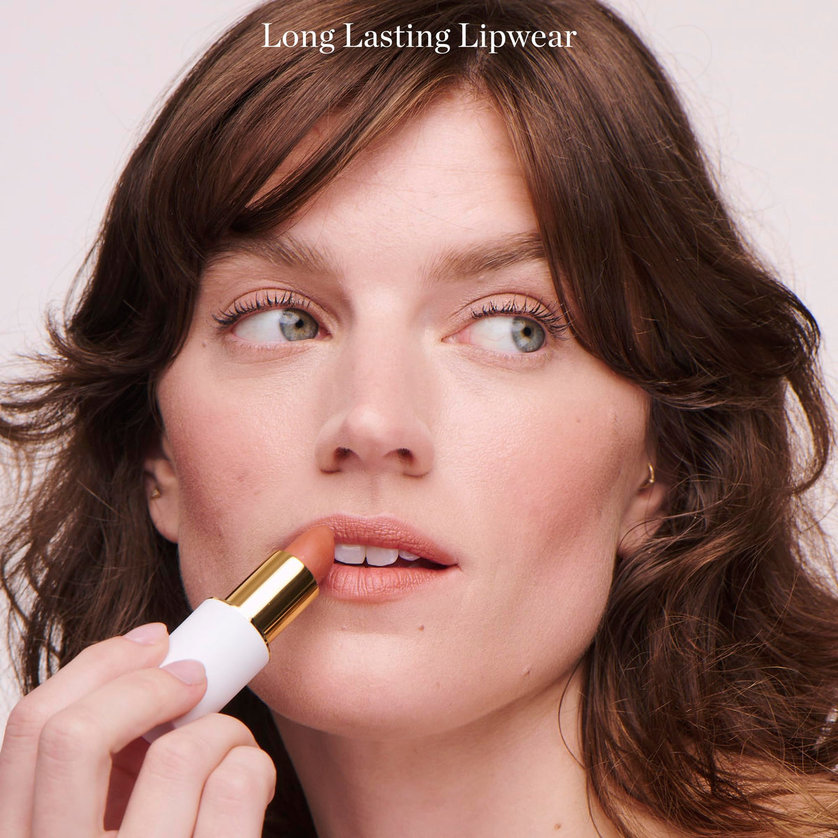 Ogee Lulu lip application on model showing full-coverage pink matte finish