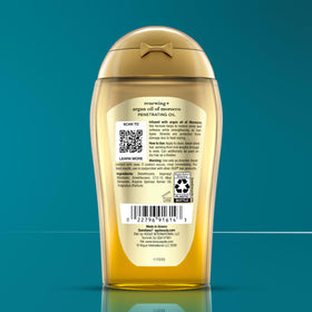 OGX Renewing Argan Oil on bathroom shelf in lifestyle setting suggesting daily use