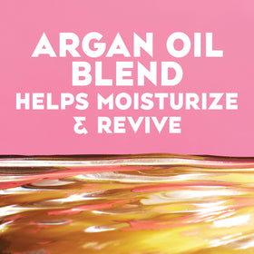 OGX ingredient label close-up highlighting argan oil and silk proteins benefit