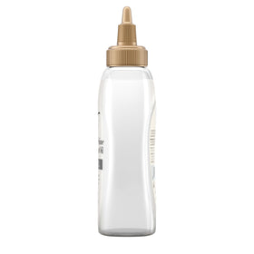 OGX bottle beside a ruler showing 4 fl oz size for travel-friendly convenience