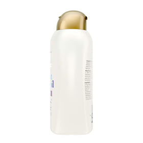 OGX shampoo pouring into hand, demonstrates smooth application