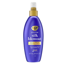 Hand holding the 6 fl oz OGX bottle to show actual product size
