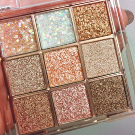 Okerker palette front view showing nine glitter shades and travel-friendly design