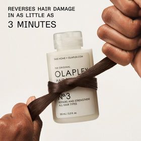 Olaplex No.3 bottle beside a measuring tube to indicate 100 mL scale and travel-friendly size