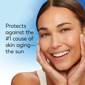 Person applying Olay SPF 30 to face during morning routine for daily protection