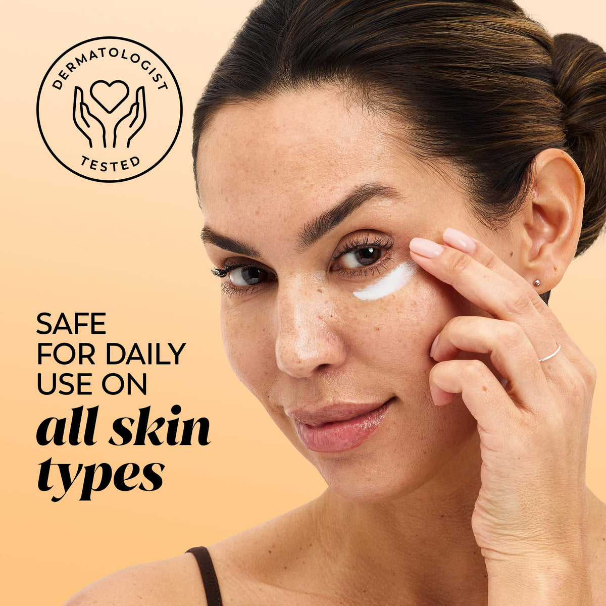 Olay cream being applied with fingertips, illustrating gentle under-eye use