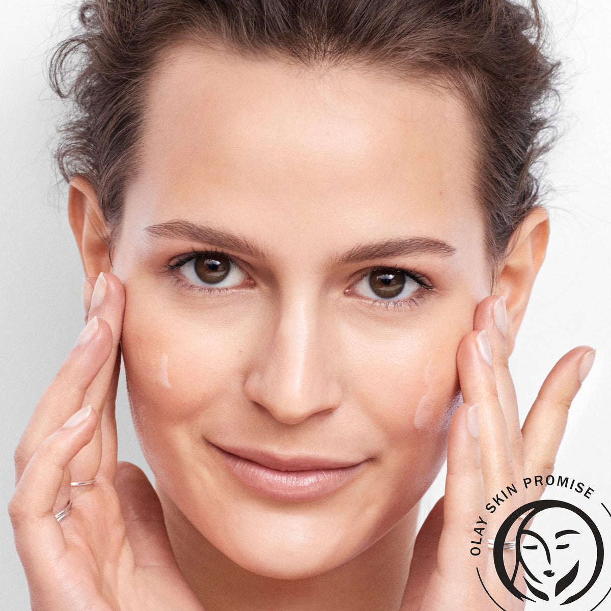 Olay serum on bathroom counter as part of routine showing daily layering benefit