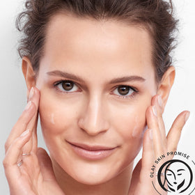 Olay serum on bathroom counter as part of routine showing daily layering benefit
