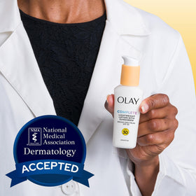 Hand showing Olay lotion absorbed quickly with non-greasy finish for makeup