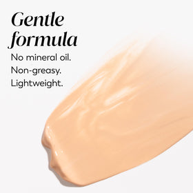 Olay product next to makeup brush showing layering under foundation benefit