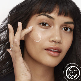 Olay 1.7 fl oz bottle next to a hand to show compact travel-friendly size