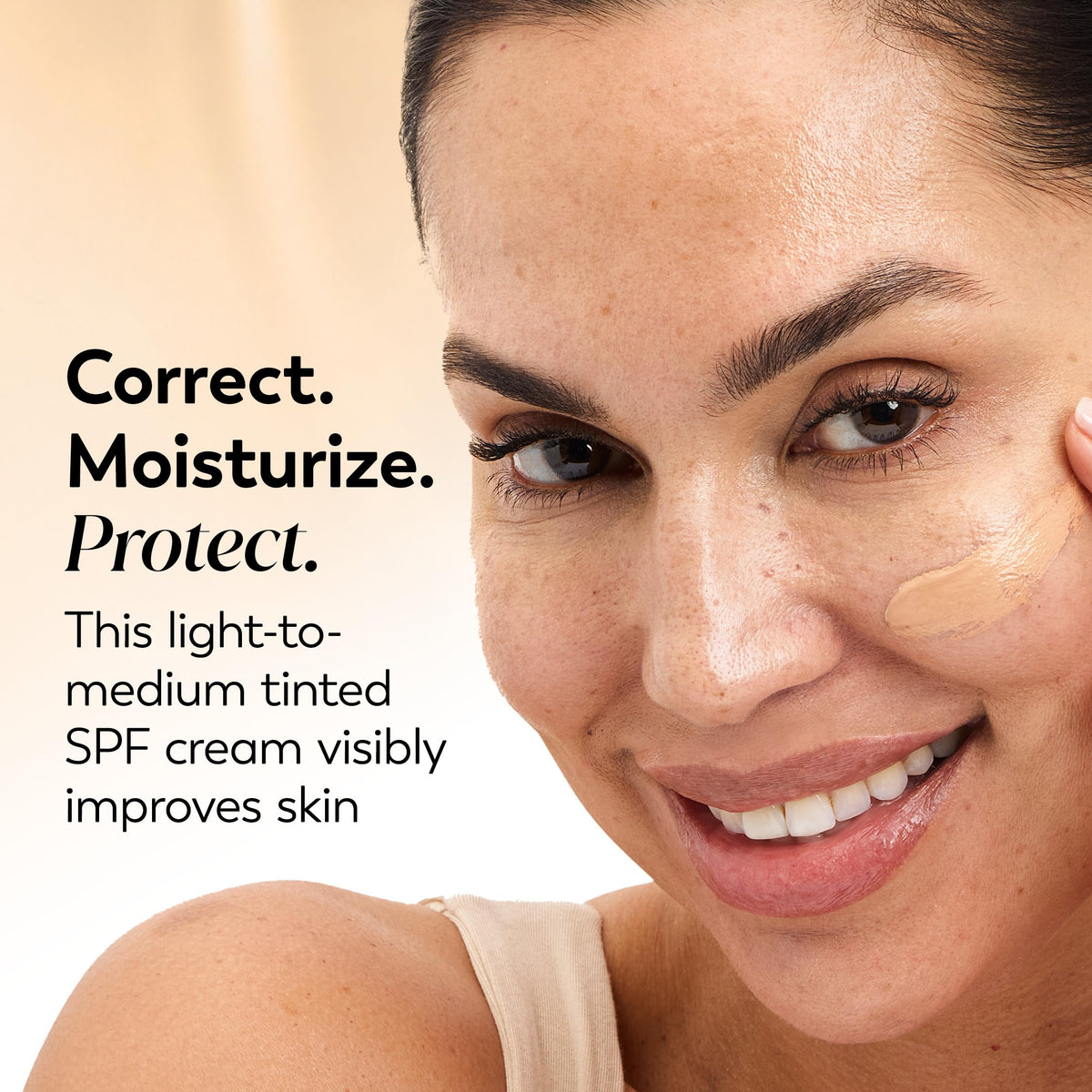 Olay tinted cream swatch on arm showing coverage and color match benefit