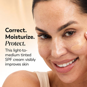 Olay tinted cream swatch on arm showing coverage and color match benefit