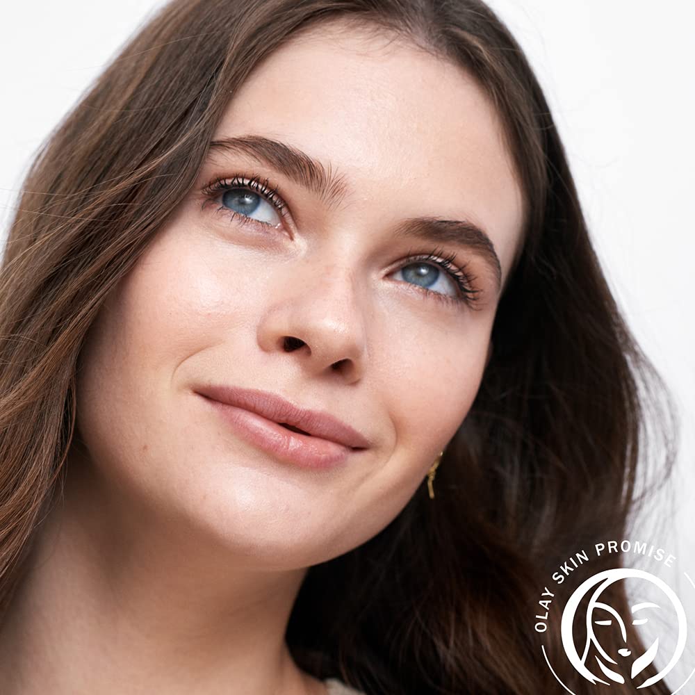 Lifestyle image of woman applying Olay toner with cotton pad for fresh skin