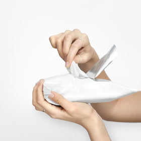 Olay wipe held in hand demonstrating easy, on-the-go makeup removal