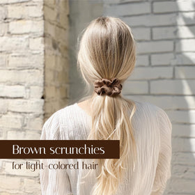 OLESILK scrunchie held in hand to show scale and gentle stretch for various hair types