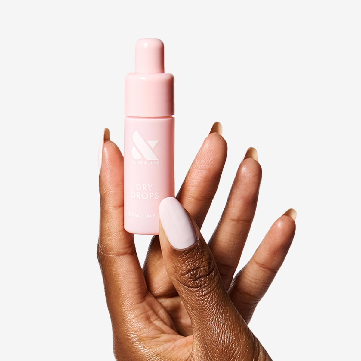 Olive & June Dry Drops one-handed applicator tip demonstrating controlled, easy application
