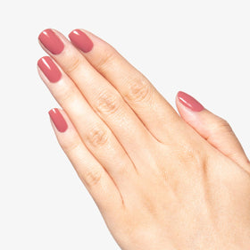 Manicure using Olive & June Boysenberry Glass showing salon-quality wear