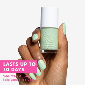 Olive & June brush close-up displays wide fan brush for easy, even application