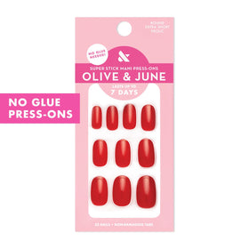 Olive & June arranged 32 press-on nails displaying sizes and cherry red color
