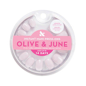 Olive & June open kit showing 42 nails, glue, and tools for effortless home application