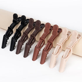 Ondder clip used during hair color application to keep sections tidy and controlled