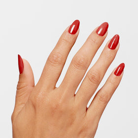 OPI Big Apple Red swatch on nail tips showing opaque two-coat coverage and shine