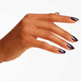 OPI swatch on forearm showing true deep red pearl color and opacity benefit