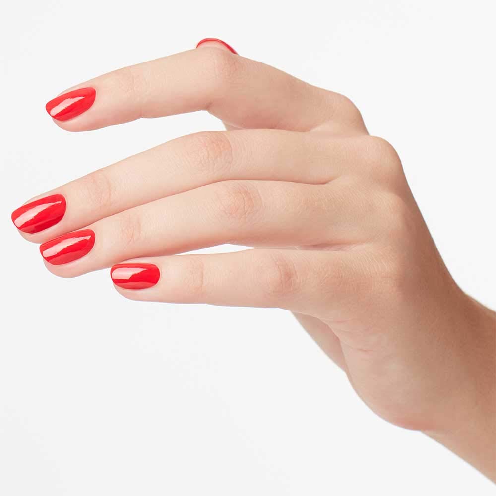 OPI Cajun Shrimp being applied to nails highlighting streak-free, fast-dry benefit