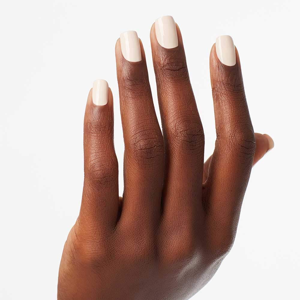 OPI manicure on hand with neutral outfit showing everyday wearability
