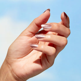 Hand model wearing OPI rose gold polish showing wearable neutral finish