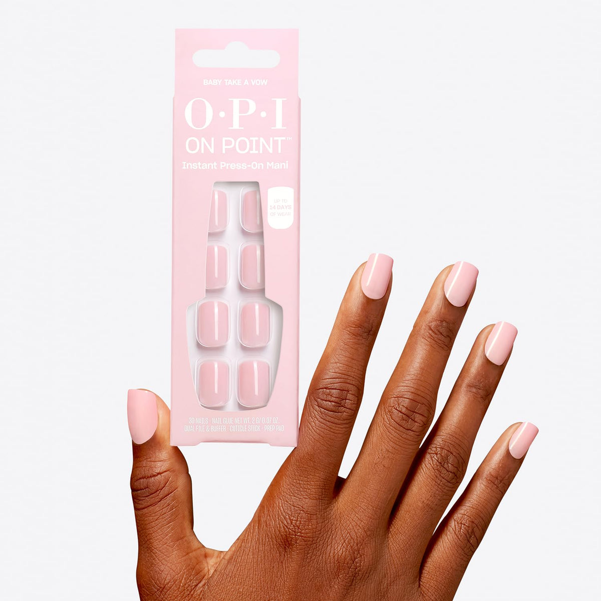 OPI Baby Take a Vow beside a ruler on a hand to show short squoval scale