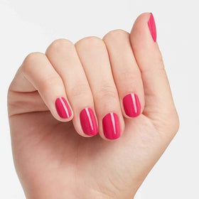 OPI painted nails on model illustrating bold pink crème and salon shine