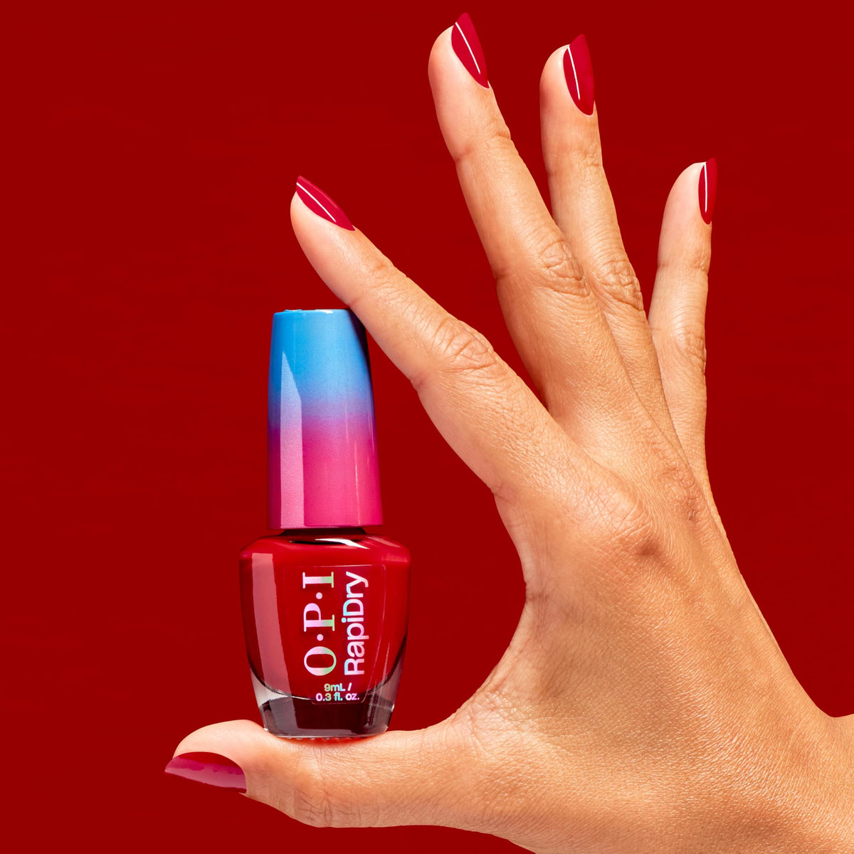 OPI RapiDry on short nails lifestyle shot demonstrating quick-dry glossy red manicure