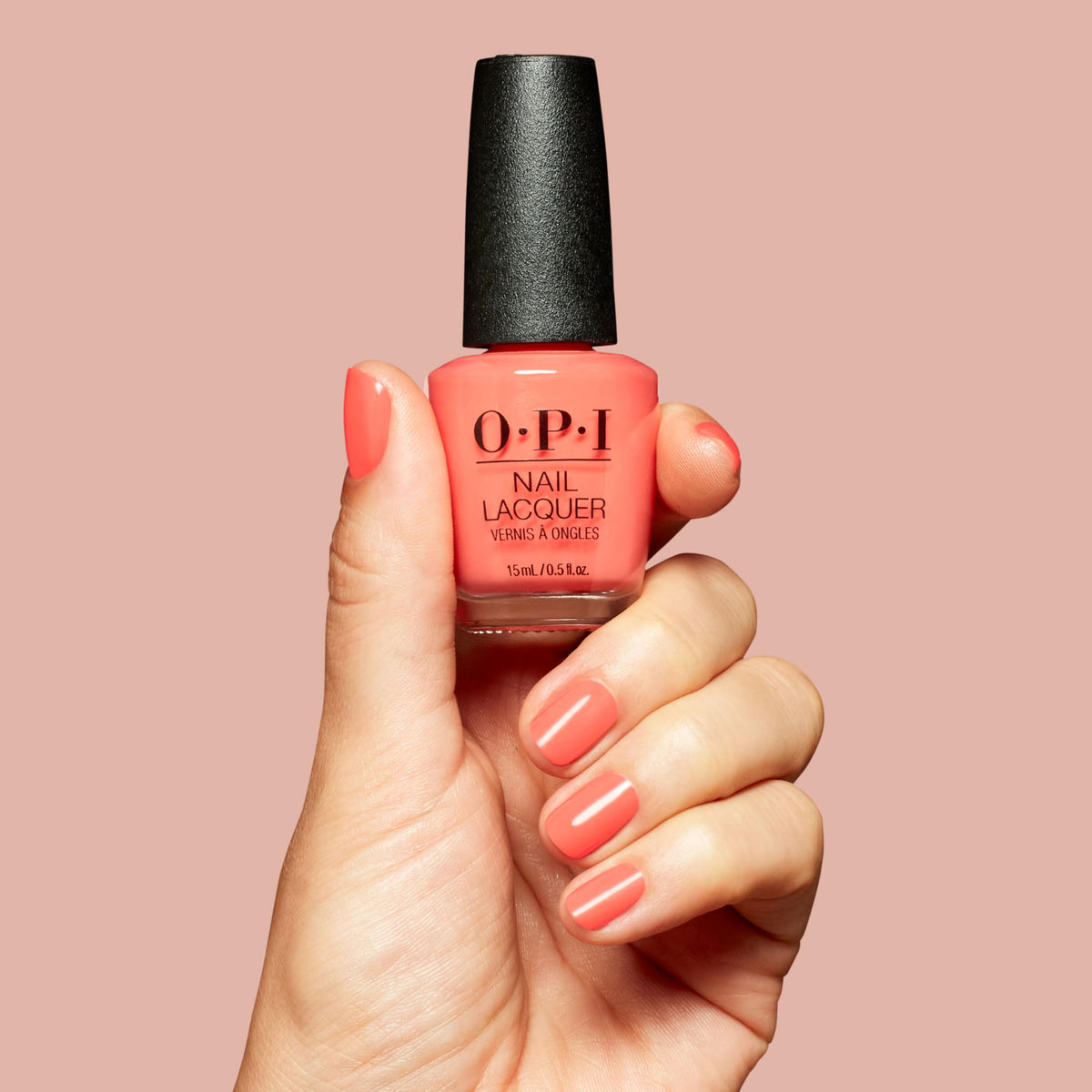 OPI Shrimp Cocktail being applied on a fingernail for even coverage
