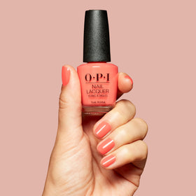 OPI Shrimp Cocktail being applied on a fingernail for even coverage