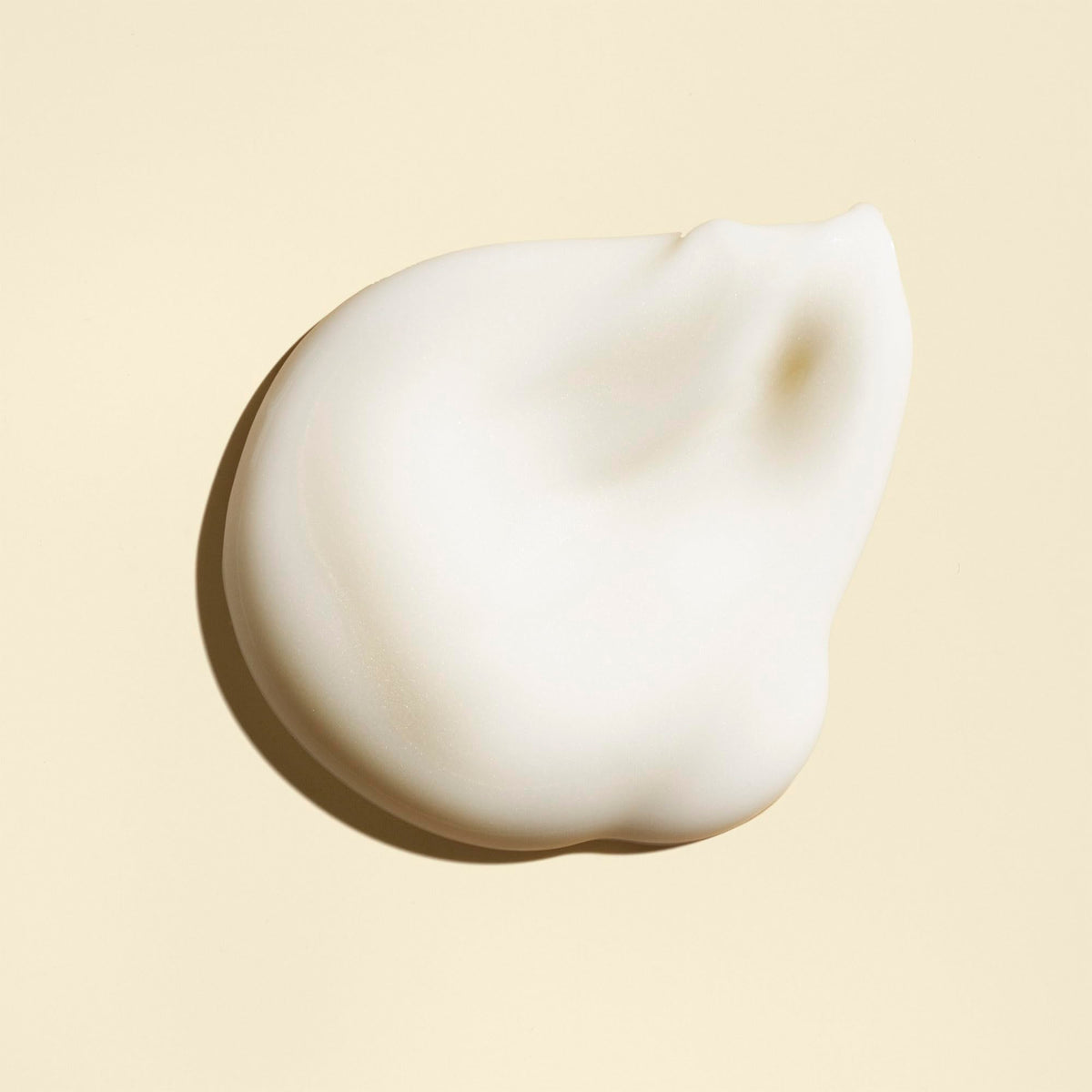 Oribe Balm D'Or being applied to damp hair demonstrating heat protection and frizz control