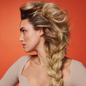 Oribe Bright Blonde on sunlit hair outdoors, demonstrates UV activation and radiant results