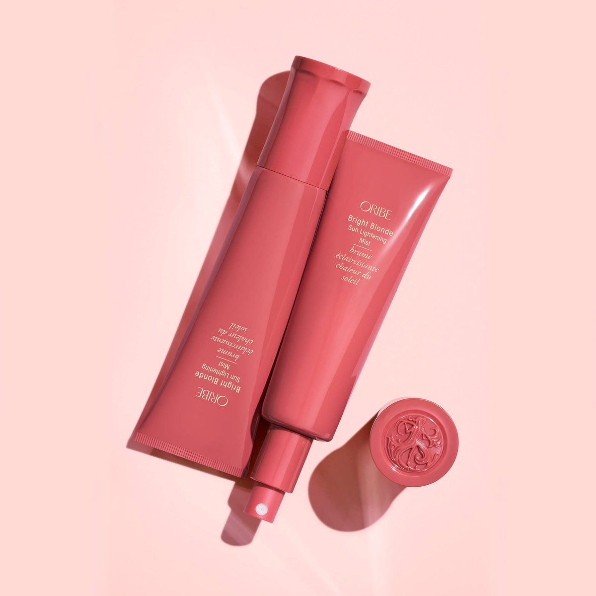 Oribe Bright Blonde mist being sprayed on hair, demonstrates easy application and brightening