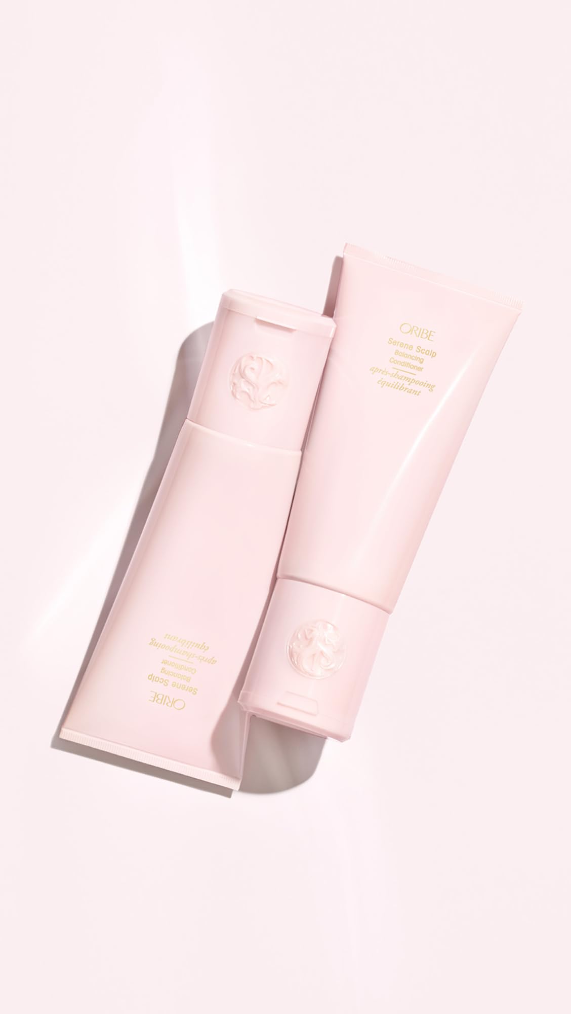 ORIBE 6.8 fl oz bottle next to common items to show true size and portability