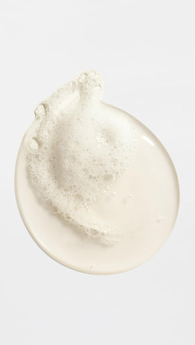 ORIBE pearlescent texture swirl close-up highlighting moisturizing formula and silky skin finish benefit