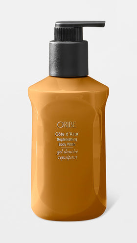 ORIBE pump dispensing creamy lather onto hand demonstrating easy application and gentle cleansing benefit
