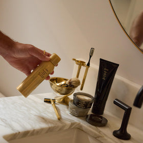 ORIBE 5 oz next to common items showing scale and travel-friendly size