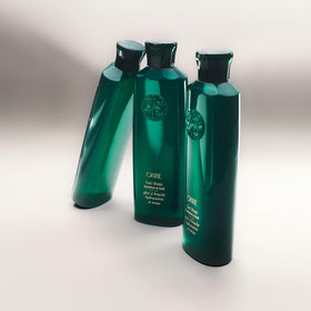 Oribe Curl Gloss applied to curly hair demonstrating defined, glossy curls
