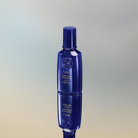 Oribe Featherbalm placed on bathroom shelf showing luxury routine and styling benefit