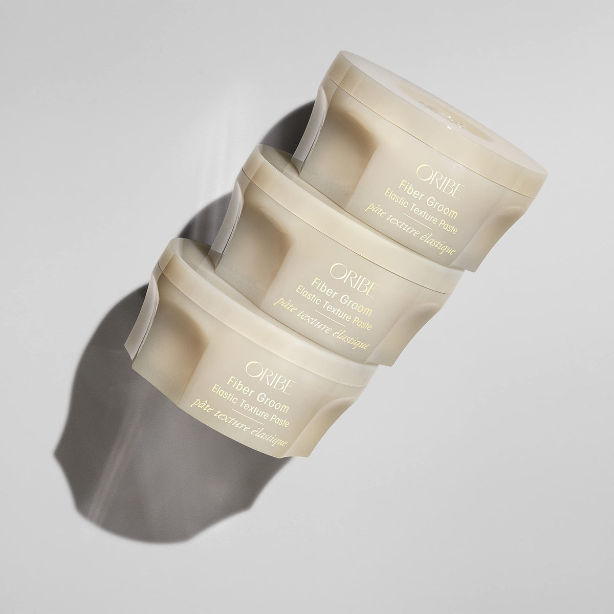 Oribe Fiber Groom texture close-up displaying paste fibers and airy consistency for definition