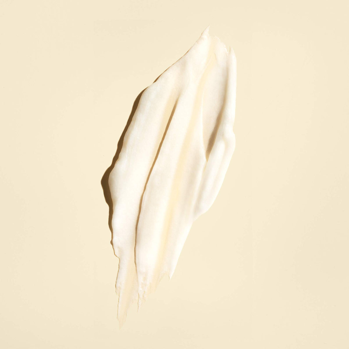 Oribe Gold Lust applied to hair lengths and ends demonstrating smoothing benefit