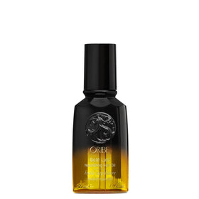 Oribe Gold Lust front bottle on white surface showing luxury packaging and shine